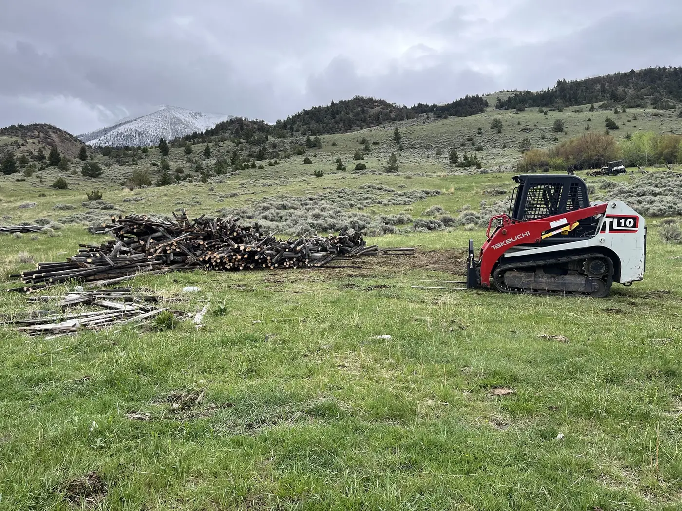 Old jackleg fence torn out and stacked for removal on a Montana pasture