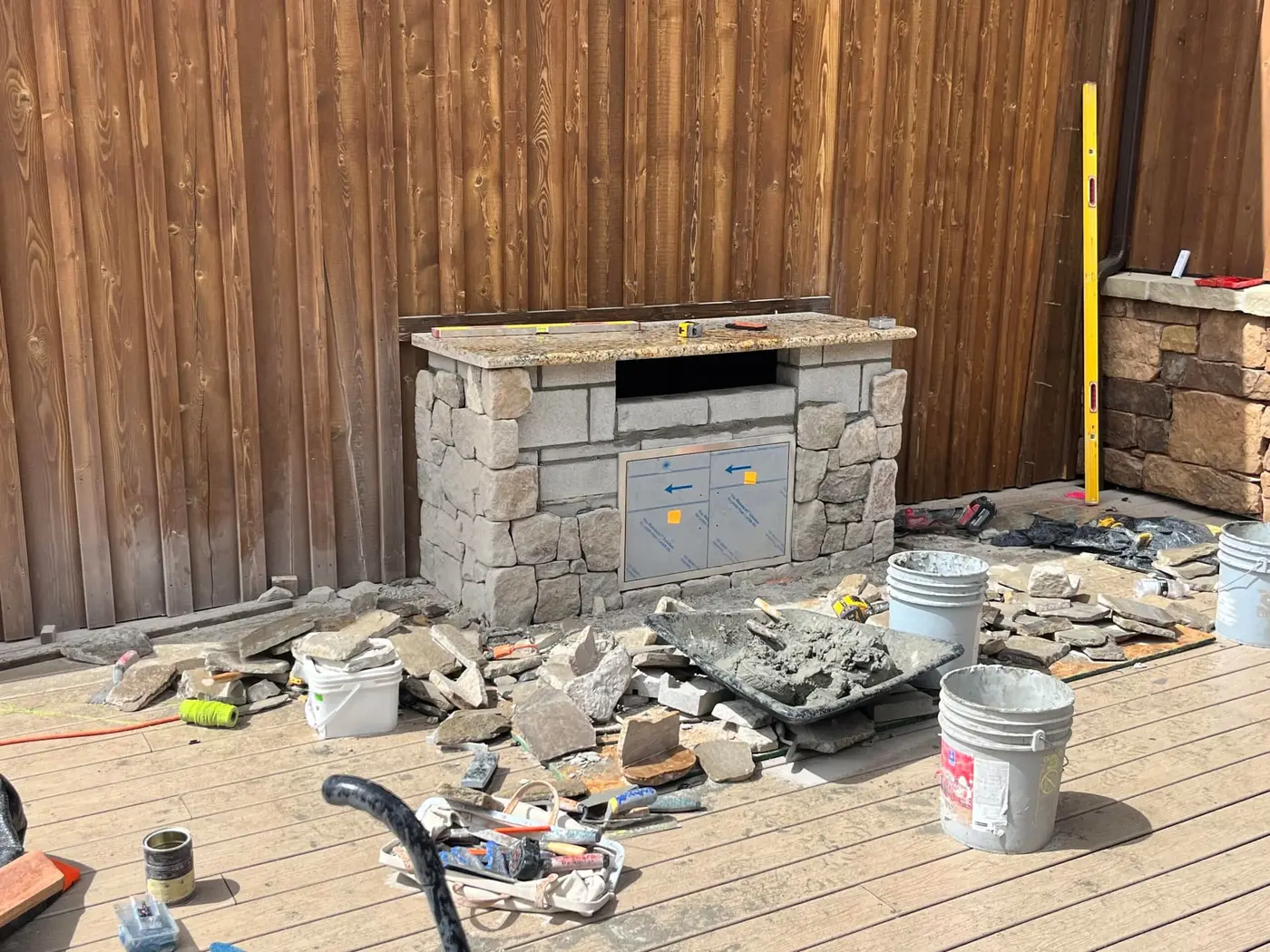 Grill island masonry under construction with appliance cutouts